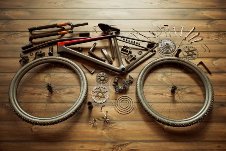 Photo for An intricate display of disassembled bicycle parts meticulously spread on a wooden floor, highlighting the elements for bike repair and assembly. - Royalty Free Image