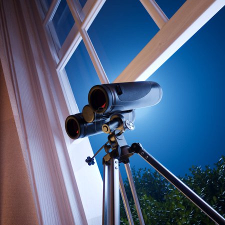 Photo for Capturing the essence of astronomy, this image showcases high-power binoculars on a sturdy tripod, poised against a twilight backdrop, offering a glimpse into celestial wonders. - Royalty Free Image