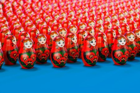 Photo for This image depicts a colorful assembly of traditional Russian Matryoshka dolls, artistically nested and adorned with intricate floral patterns, showcased on a vivid blue background. - Royalty Free Image