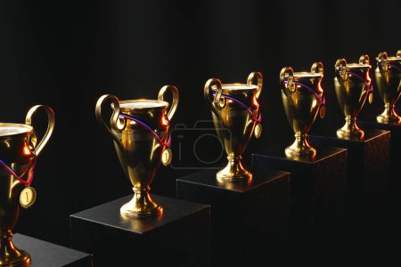Foto de Una elegante muestra de múltiples prestigiosos trofeos dorados adornados con cintas vibrantes, exhibidos en pedestales, ejemplificando el pináculo del éxito competitivo y el honor. - Imagen libre de derechos