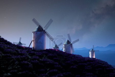 Téléchargez les photos : Un tableau nocturne majestueux où les moulins à vent traditionnels se dressent haut au milieu de champs de lavande en fleurs, baignés sous une verrière stellaire impressionnante, illustrant la tranquillité des natures - en image libre de droit