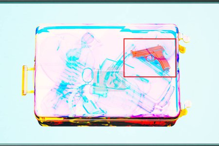 Photo for Intense X-ray screening at an airport security checkpoint unveils a hidden firearm within a piece of carry-on baggage, highlighting the critical nature of safety protocols. - Royalty Free Image