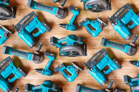 An expansive array of the latest cordless power tools neatly displayed against a wooden backdrop, highlighting essential equipment for home improvement and professional building tasks.