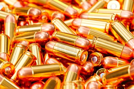 Photo for This image captures a close-up view of numerous golden bullet casings, highlighting their metallic sheen and the precision of their craft, evoking themes of military and defense. - Royalty Free Image