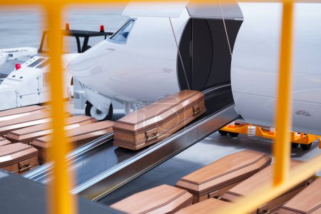 A solemn view capturing the precise moment wooden coffins are loaded onto an airplane, representing the dignified transportation of the deceased.
