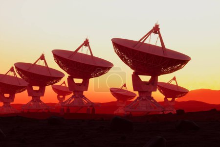 Téléchargez les photos : La silhouette d'un grand réseau de radiotélescopes se dresse contre un coucher de soleil éclatant, incarnant l'intersection de l'ingéniosité humaine et la quête de percer les mystères cosmiques. - en image libre de droit