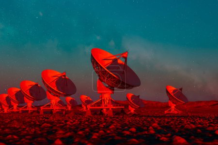 Una impresionante red de radiotelescopios rojos bajo el cielo estrellado del crepúsculo, mostrando tecnología avanzada en la búsqueda del conocimiento cósmico.