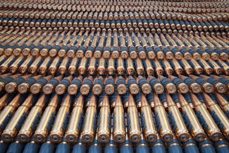 This meticulous close-up captures a multitude of uniformly positioned bullets, highlighting their symmetrical arrangement and the distinct gleam of metallic casings.
