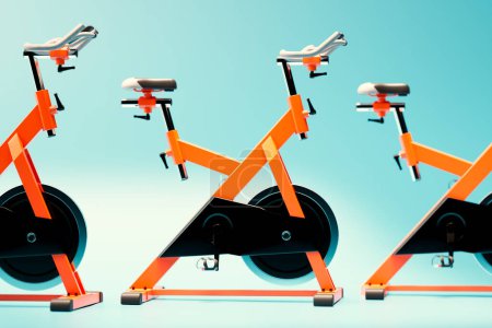 Photo for A captivating array of three high-end orange stationary bikes in a fitness room, boasting sleek designs and positioned ready for an intense indoor cycling session. - Royalty Free Image