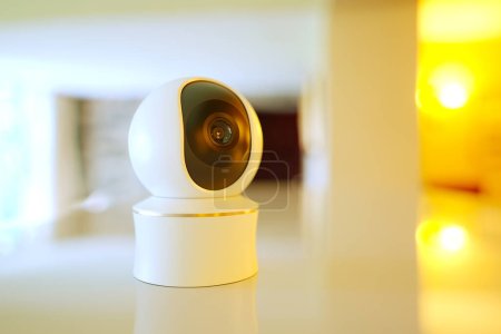 A cutting-edge indoor security camera with smart surveillance capabilities perfectly blends with home decor, ensuring real-time safety and monitoring in a warmly lit setting.
