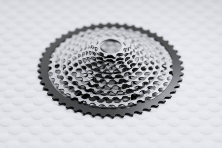Photo for Precision-engineered bicycle gear cassette in sharp focus, showcased on a seamless white background, exemplifying mechanical craftsmanship. - Royalty Free Image
