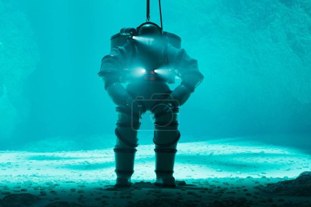 Photo for Captured in the tranquility of the ocean depths, a diver encased in a timeless heavy diving suit is surrounded by the underwater world, with only the glow of the suit's lights piercing the darkness. - Royalty Free Image