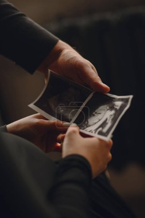 Close up photo of pregnant woman and her husband holding the ultrasound picture. Love concept. Family concept. The concept of happy parenthood