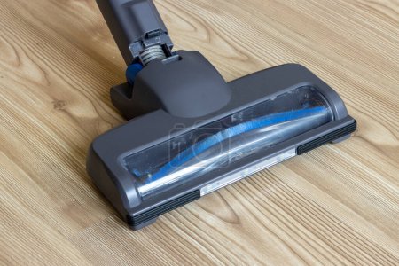 Lighted vacuum cleaner head on parquet floor