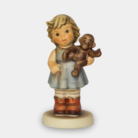Goebel Hummel Porcelain Figurine of Girl in Blue Dress with Toy Monkey. High quality photo