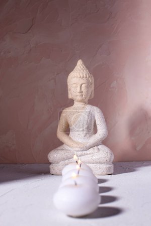 Photo for Wellness concept with  row of burning candles and statue of Buddha  on textured background.  Religion concept. Selecctive focus is on Buddha. - Royalty Free Image