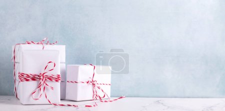 Photo for Postcard with  wrapped boxes with presents against  blue textured  wall. Scandinavian style. Place for text. - Royalty Free Image