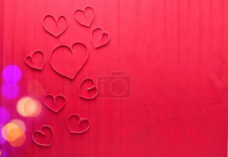 Photo for Border from pink paper hearts on red textured paper surface. Top view. Place for text. Valentine day, Mothers day concept. - Royalty Free Image