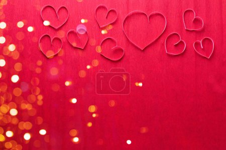 Photo for Romantic postcard. Pink paper hearts on red textured paper surface. Top view. Place for text. Valentine day, Mothers day concept. - Royalty Free Image