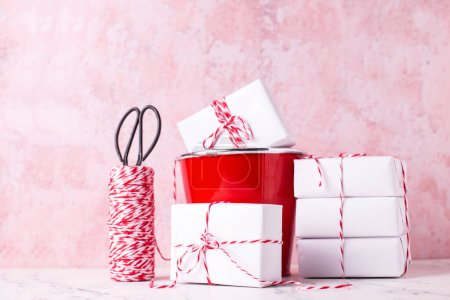 Photo for Composition with  wrapped boxes with presents against pink textured  wall. Scandinavian style. Place for text. - Royalty Free Image
