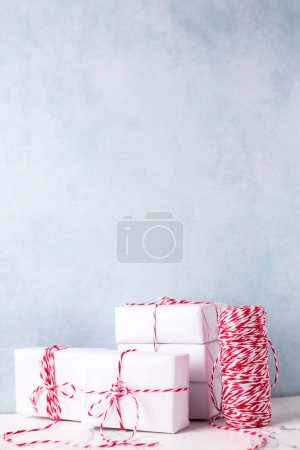 Photo for Postcard with  wrapped boxes with presents, bikers twine against  blue textured  wall. Scandinavian style. Place for text. - Royalty Free Image