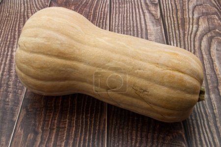 Téléchargez les photos : Fresh butternut squash over wooden background - en image libre de droit
