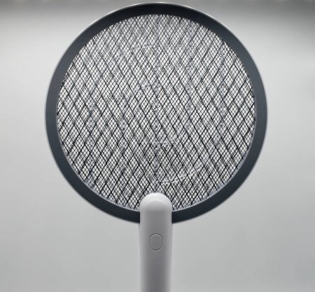 Photo for Electric Fly and Mosquito Swatter on charging base. Electric Insect killer. Isolated on white. - Royalty Free Image