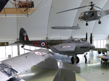 Photo for Hendon, London - England, UK - June 29, 2014: Royal Air Force (RAF) Museum. Real historic aircrafts from all over the world. In foreground a British Mosquito. - Royalty Free Image