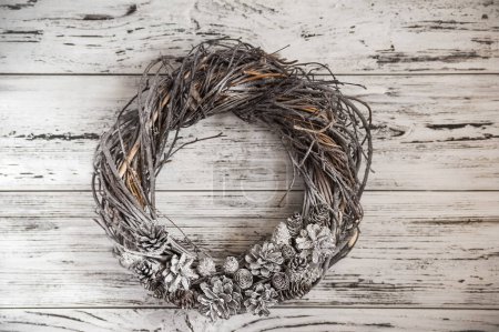 Photo for Christmas wreath with cones close-up and copy space. Wreath with snow on wooden background - Royalty Free Image