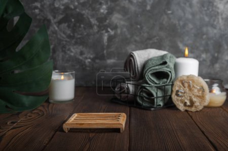 Photo for Podium in bathroom and natural soap, loofah scrubber. Zero waste in life. Relaxation spa concept, candles, beauty. - Royalty Free Image