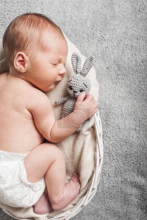 Photo for Newborn 3 weeks sleeping with rabbit toy close up. Baby care, colic, teething, healthy sleep. - Royalty Free Image