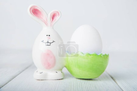 Photo for Happy Easter greeting card. Rabbits, colorful eggs, spring flowers with tag for text. - Royalty Free Image
