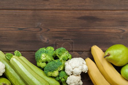 Photo for Heart made of fresh vegetables and fruit on wooden background. - Royalty Free Image