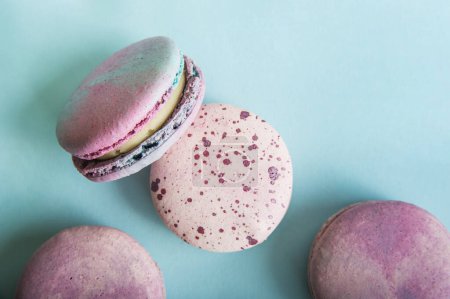 Photo for Pink macaroons on blue background close-up and empty space. - Royalty Free Image