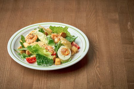 Photo for Salad with vegetables, tuna and boiled egg. Nicoise salad. Wooden background - Royalty Free Image