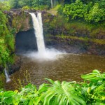 Wailuku River State Park Waterfall framed with verdant greenery.