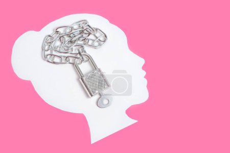 Photo for Padlock and chain placed on a white female face shape isolated on a pink background with copy space. Creative personal data protection concept. - Royalty Free Image