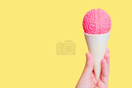 Photo for Dessert with a Twist: Waffle cone adorned with an intricately crafted human brain model in hand. Brain freeze dessert. - Royalty Free Image