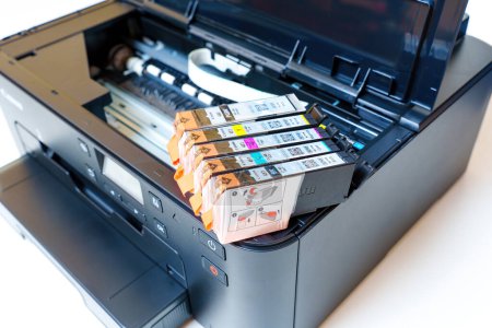 Photo for Kyiv, Ukraine - July 20, 2023: Close-up of fresh Canon ink cartridges place on an inkjet printer ready for installation. - Royalty Free Image