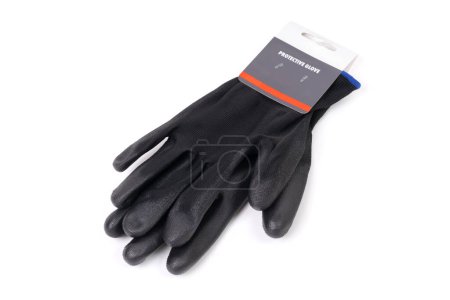 Top view of a pair of black protective gloves, complete with a tag, isolated on white background. Safety gear, construction, maintenance, and industrial work related concept.