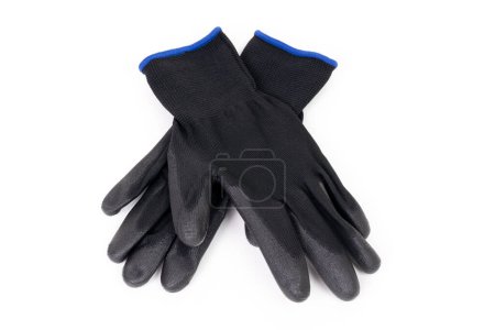 Close-up of a pair of black cut-resistant knitted gloves isolated on white background. Personal protection and safety equipment concept.
