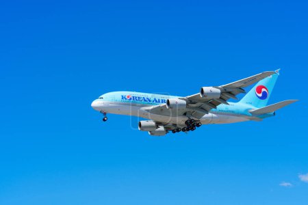 Photo for Los Angeles, California - April 9, 2024: A close-up of a Korean Air airplane flying high, set against a bright blue sky. - Royalty Free Image