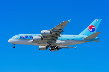Photo for Los Angeles, California - April 9, 2024: Side perspective of a Korean Air airplane in flight, captured in a close-up shot isolated against a blue sky. - Royalty Free Image