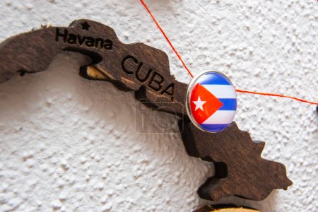 Photo for Cuba flag on the pushpin with red thread showed the paths of movement or areas of influence in the global economy on the wooden map. Planning of traveling or logistic concept. Network connection. - Royalty Free Image