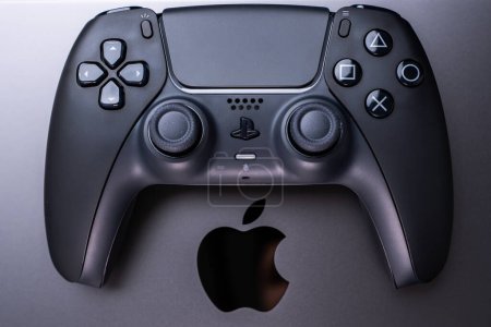 Photo for BERLIN , GERMANY - JANUARY 14 2024: A detailed view of a video game controller, suitable for gaming on Apple MacBook Pro Space Black. - Royalty Free Image