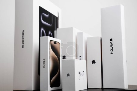 Photo for BERLIN , GERMANY - FEBRUARY 14 2024: MacBook Pro. iPhone, Air Pods Apple watch boxes standing on the table. - Royalty Free Image