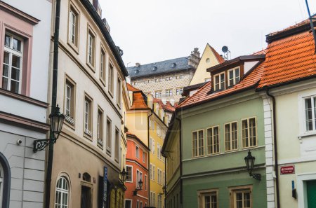 A historical colorful street of Lesser Town with a view of Schwarzenberg Palace, Prague, the Czech Republic