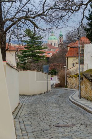 A view of Saint Nicolas Church from historical Vlasska Street in Lesser Town in Prague, the Czech Republic