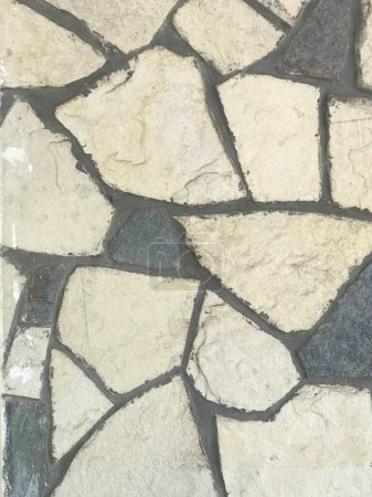 irregularly shaped stones of a wall covering