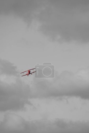 small plane doing pirouettes in the cloudy sky